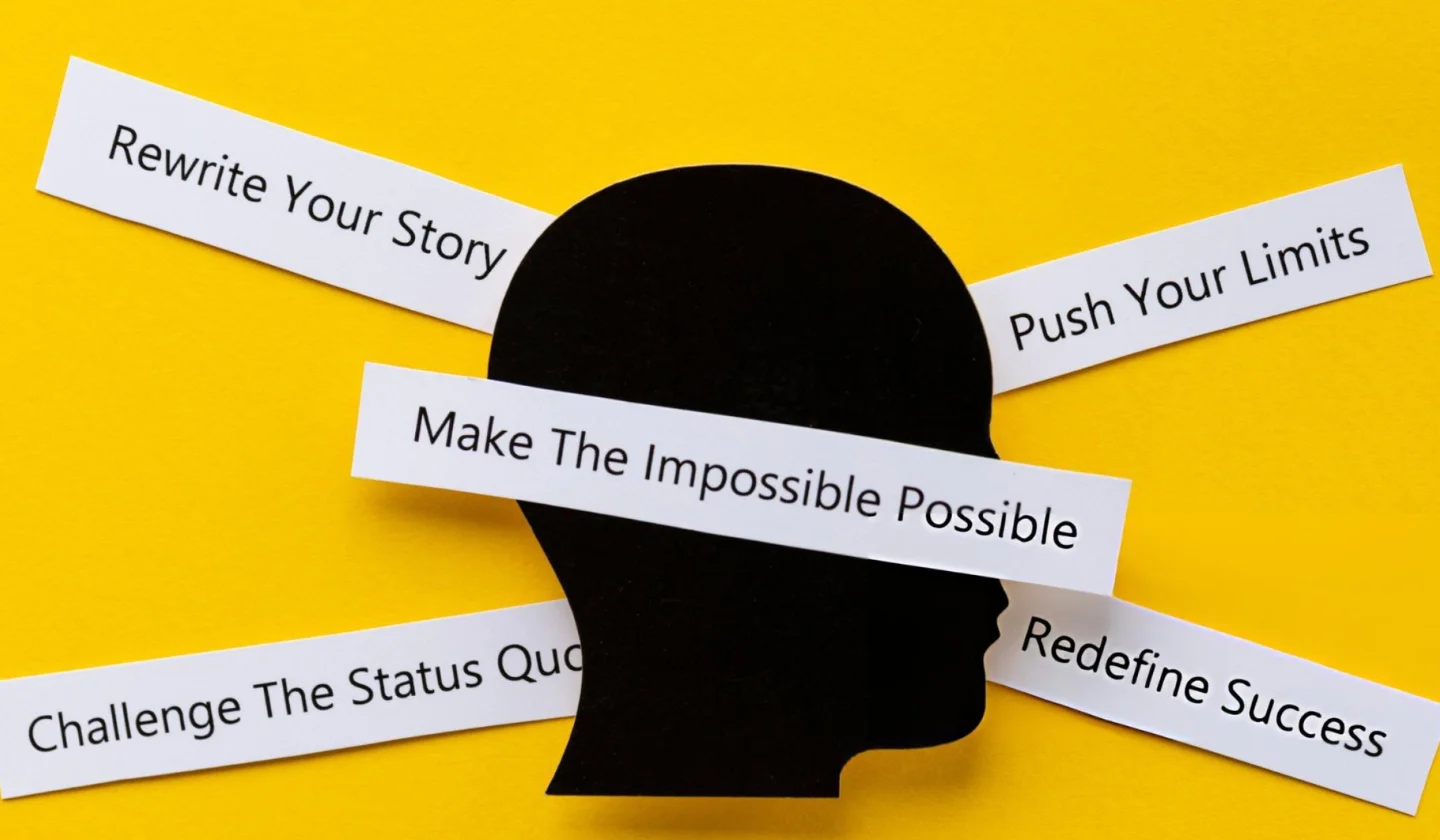 Motivational cards on a desk with words like Push, Make, The, Impossible, Possible
